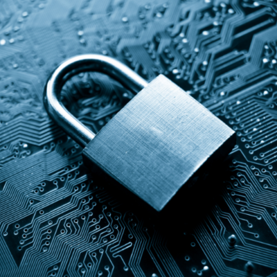 padlock lying atop a computer circuit board