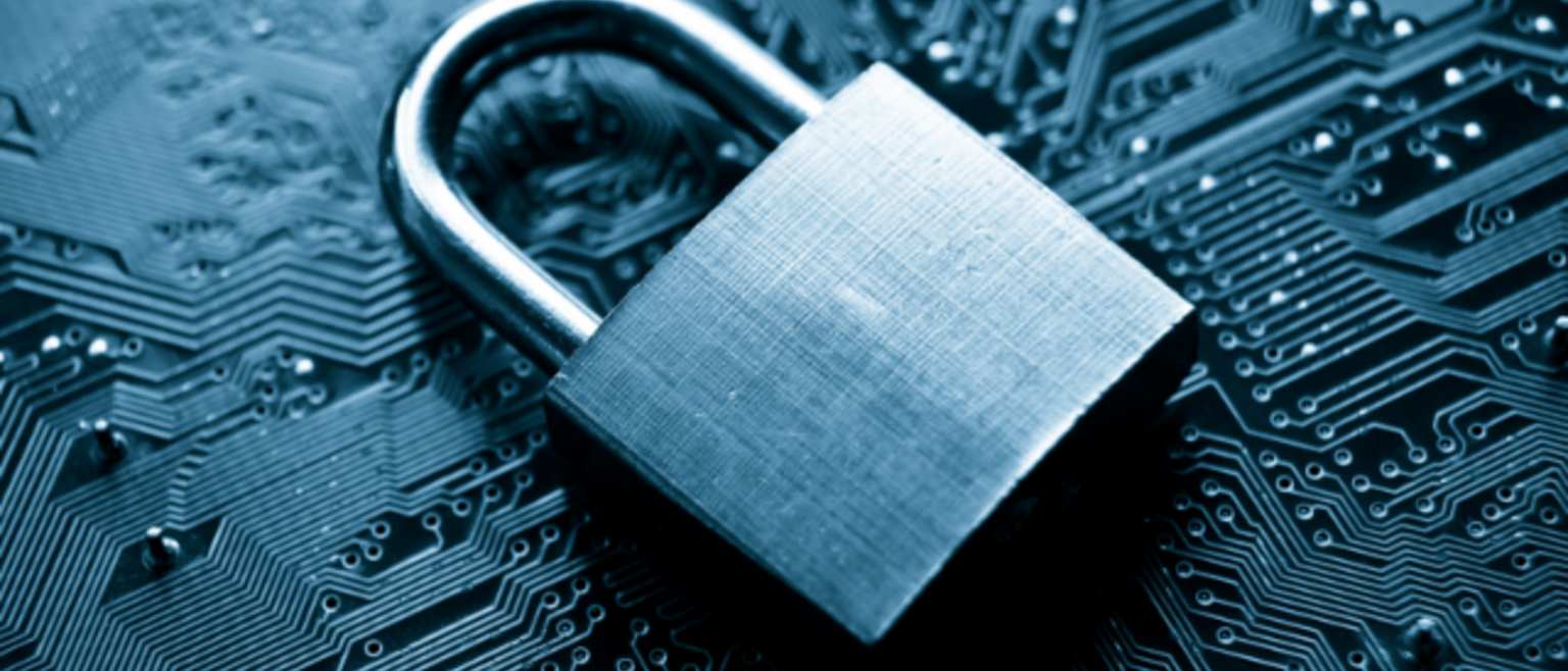 padlock lying atop a computer circuit board
